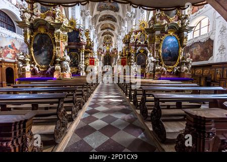 Neuzelle Baroque Monastery, Germany. The interior of the monastery church looks unusually long towards the main altar in the east. This impression is created by the multitude of side altars. They surround the pillars and grow upwards from them as they are further away. Thus they form a boulevard to the high altar Stock Photo