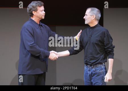Nike Mark Parker, left, and Apple CEO Steve Jobs shake news conference in New York, May 23, 2006. Nike and Apple introduced the Air Zoom Moire, the first