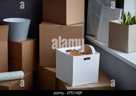 Domestic things packing in container and cardboard boxes for relocation Stock Photo