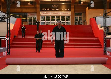 Technicians replace the red carpet between premieres at the 59th International film festival in Cannes, southern France, on Saturday, May 20, 2006. (AP Photo/Laurent Emmanuel)