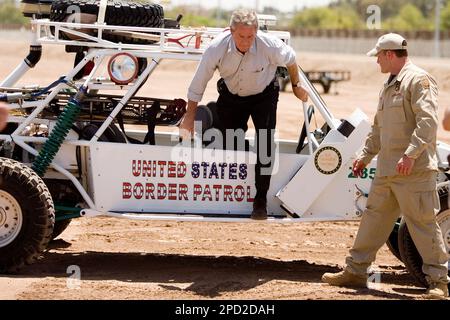 President Bush climbs out of a sand rail with United States Border Patrol agent Rocky Kittle near the U.S. Mexico border west of the San Luis Ariz. port of entry Thursday May 18