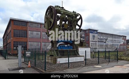 Eisenach, Germany. 14th Mar, 2023. A double-crank toggle deep-drawing press built in 1928 stands in front of the industrial monument 'O1', formerly the main plant of BMW automobile production, on the site of the former Eisenach automobile plant. The city is planning to build a multifunctional hall in the building, which has been vacant for more than 20 years, to be used primarily as a sports facility for school, competitive and club sports. Credit: Martin Schutt/dpa/Alamy Live News Stock Photo