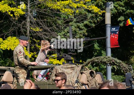 Warsaw, Poland - August 14, 2022 - Soldier and girl with 12.7mm heavy machine gun on Jackal armoured reconnaissance vehicle during Polish Army Day (Ar Stock Photo