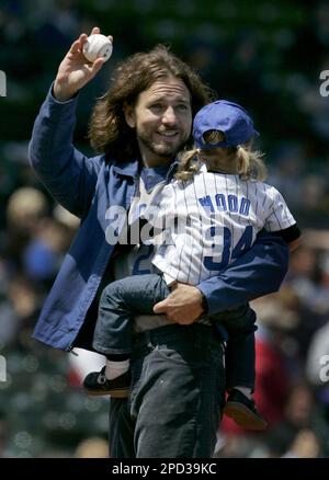 Pearl Jam frontman Eddie Vedder tries on a Chicago Cubs jersey as