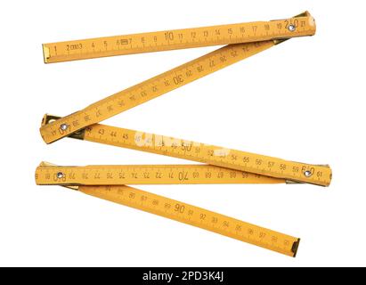 Yellow folding wooden ruler, retro style, isolated on white background Stock Photo