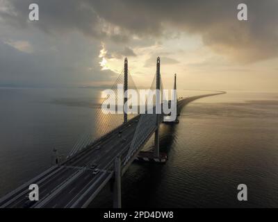 Batu Maung, Penang, Malaysia - Mar 11 2022: Sunrise with dramatic cloud during sunrise at Penang Second Bridge Stock Photo