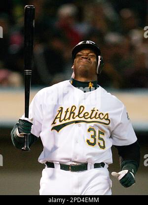 athletics 256 ls.JPG Bottom: Athletics' Frank Thomas reacts after the ball  hits him after swinging at a pitch in the second inning. An unidentified  trainer talks with him. Athletics manager Ken Macha