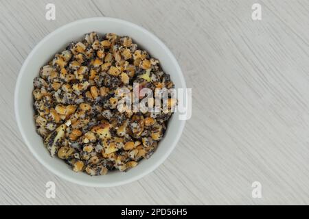 Ukrainian kutia with wheat, raisins, poppy seeds, walnuts, dried apples in bowl in wood background. Top view. Stock Photo