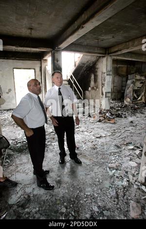 New Zealand Defense Minister Phil Goff, right, High Commissioner Brian  Sanders, center, and lawmaker Ron Mark take a first hand look at the damage  caused during the April 18 rioting and looting