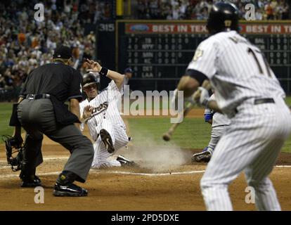 Houston Astros' Willy Taveras, bottom, slides safely into third for a  triple past Cincinnati Reds third baseman Joe Randa during the sixth inning  Friday, April 15, 2005, in Cincinnati. (AP Photo/David Kohl