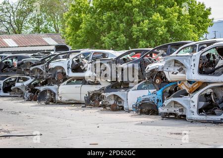 Car part salvage yard with rows of stacked wrecked cars Stock Photo - Alamy