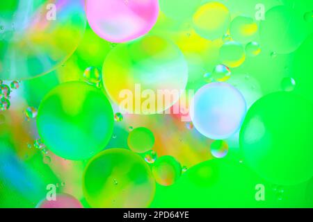 Multi colored abstract background with oil circles on water surface with a green background Stock Photo