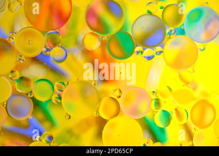 Bright abstract multicolored background with oil circles on a yellow base Stock Photo