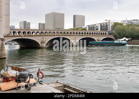 Pont de Bercy combined Road and Rail Bridge across River Seine with a boat about to go through the bridge, Paris, France Stock Photo