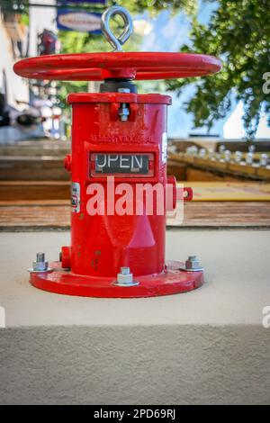 Emergency fire sprinkler water shut off valve on side of building Stock Photo