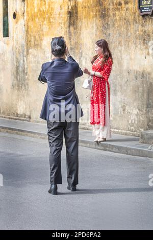 A vietnamese couple taking street photographs in Hoi An, Vietnam. Stock Photo
