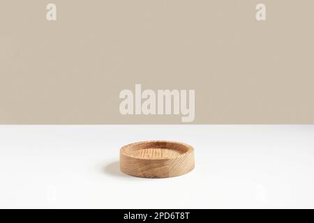 Podium for cosmetic product presentation. Abstract minimal geometrical form on white background. One wooden form, shadow. Scene, Showcase, display. Mi Stock Photo