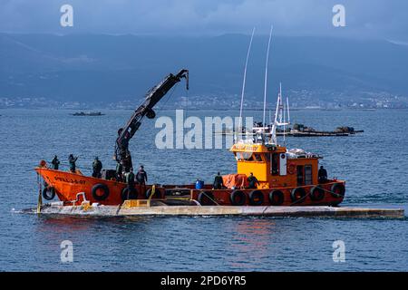 March 14, 2023, Vilagarcia de Arousa, Pontevedra, EspaÃ±a: Police forces tow submarine drug to the Varadoiro do Xufre in the Illa de Arousa of the province of Pontevedra in Galicia, Spain (Credit Image: © Elena Fernandez/ZUMA Press Wire) EDITORIAL USAGE ONLY! Not for Commercial USAGE! Stock Photo