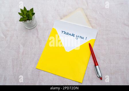 Thank you note in an envelope Stock Photo