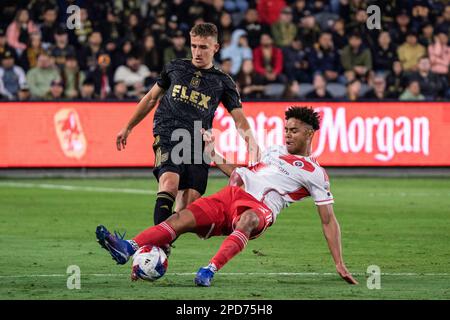 March 15, 2023: LAFC forward Denis Bouanga holds off the challenge