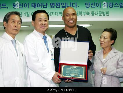 Hines Ward, 2nd right, of the Pittsburgh Steelers presents South