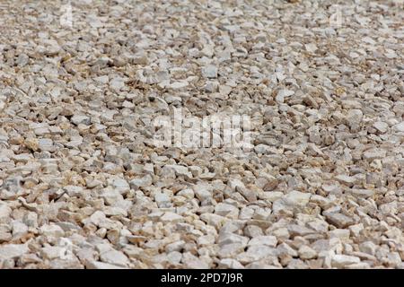 Gravel of large fractions Crushed stone building aggregate stone structure. Crushed Stone close-up Lies on ground. Breakstone. Granite gravel construc Stock Photo