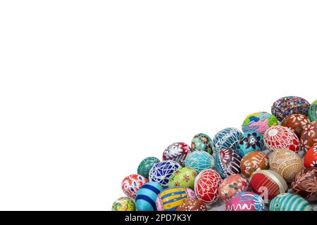 A collection of colorful Easter eggs arranged close together in the lower corner of the frame. Stock Photo