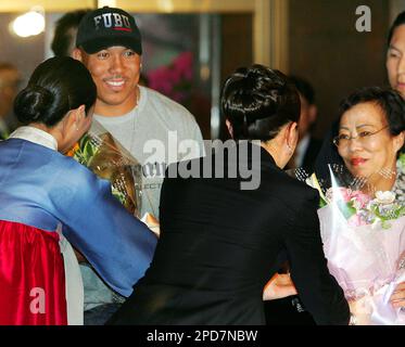 Half-Korean Super Bowl MVP Hines Ward of the Pittsburgh Steelers, right,  kisses his Korean mother Kim Young-hee upon their arrival at Incheon  International Airport, west of Seoul, South Korea, Monday, April 3