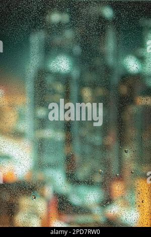 Raindrops on glass during rain, large drops. Landscape with raindrops falling on the window of the house. Blurred horizon view. macro photo Stock Photo
