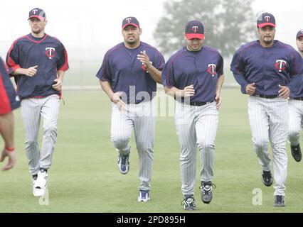 Minnesota Twins pitchers, from left, Jose Lugo, Jeff Manship and Rob  Delaney follow drills on the first day of full squad workout at baseball  spring training in Fort Myers, Fla., Saturday, Feb.