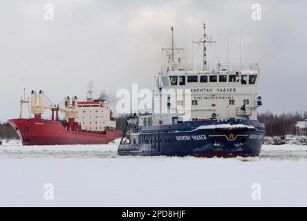 February, 2023 - Arkhangelsk. Conducting a dry cargo ship to the port. Icebreaker 'Captain Chadaev' and timber carrier 'Polar King'. Russia, Arkhangel Stock Photo