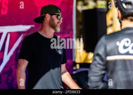 A man in a black shirt and cap looking off into the distance Stock Photo