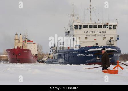 February, 2023 - Arkhangelsk. Conducting a dry cargo ship to the port. Icebreaker 'Captain Chadaev' and timber carrier 'Polar King'. Russia, Arkhangel Stock Photo