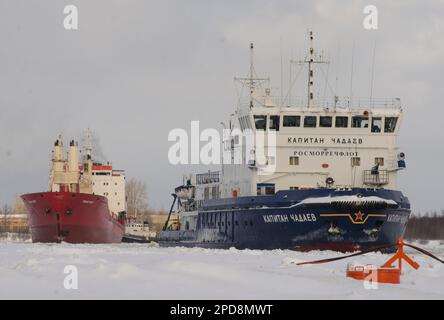 February, 2023 - Arkhangelsk. Conducting a dry cargo ship to the port. Icebreaker 'Captain Chadaev' and timber carrier 'Polar King'. Russia, Arkhangel Stock Photo