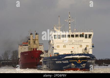 February, 2023 - Arkhangelsk. Conducting a dry cargo ship to the port. Icebreaker 'Captain Chadaev' and timber carrier 'Polar King'. Russia, Arkhangel Stock Photo