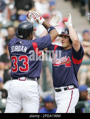 Atlanta Braves outfielder Brian Jordan, right, celebrates with his