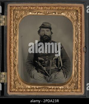 A. J. Blue, cavalry soldier in Union shell jacket and bummer cap with three Remington revolvers in his belt, holding a sword. Liljenquist Family Collection of Civil War Photographs , pp/liljunion. United States, Army, People, 1860-1870, Soldiers, Union, 1860-1870, Military uniforms, Union, 1860-1870, Handguns, 1860-1870, Daggers & swords, 1860-1870, United States, History, Civil War, 1861-1865, Military personnel, Union. Stock Photo