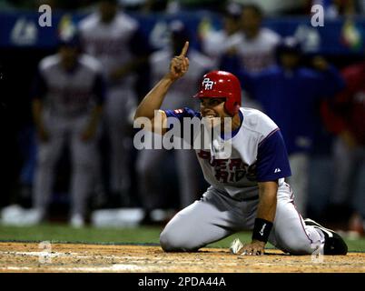 Puerto Rico catcher Ivan Rodriguez yells from home plate as he waits for  runner Carlos Beltran to score against Cuba in the fourth inning during the  first round of the World Baseball