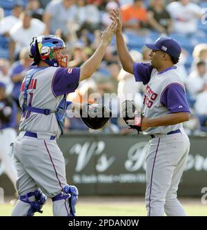 Puerto Rico's catcher Yadier Molina (4) chases down Japan's Seiichi  Uchikawa (24) after he was caught stealing in the eighth inning in the semi  finals of the World Baseball Classic at AT&T