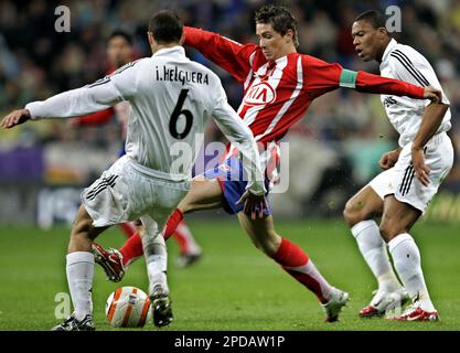 Liverpool's Fernando Torres, right, heads the ball past Real Madrid 's  Pepe, of Brazil, during a Champions League, Round of 16, first leg soccer  match against Real Madrid at the Santiago Bernabeu