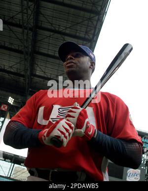 Team USA outfielder Ken Griffey Jr. jokes with teammates fielding