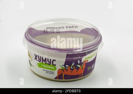 Kyiv, Ukraine - November 06, 2021: Studio shoot of Hangry Papa hummus with zaatar packade closeup on white. It is a dip, spread, made from cooked, mas Stock Photo