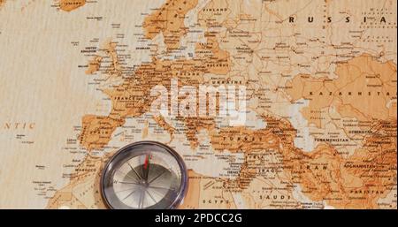 Image of compass lying on world map Stock Photo
