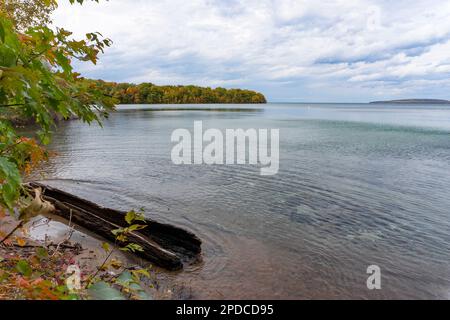 Autumn landscape with a lake and colorful forest on a cloudy day Stock Photo