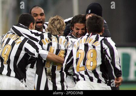 Juventus striker Alessandro Del Piero, center, followed by teammate Giorgio  Chiellini, left, with other teammates, warms-up next to an Italian Serie B  second division sign, at bottom, before the start of the