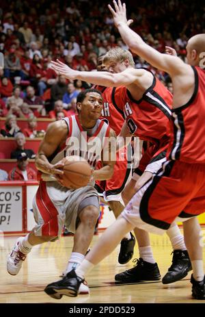 https://l450v.alamy.com/450v/2pdd529/new-mexicos-mark-walters-left-drives-against-the-defense-of-utahs-luke-nevill-middle-and-shaun-green-right-during-the-second-half-of-a-college-basketball-game-at-the-pit-in-albuquerque-nm-saturday-feb-4-2006-walters-scored-14-points-in-the-game-to-help-lead-new-mexico-to-a-64-53-win-ap-photojake-schoellkopf-2pdd529.jpg