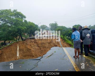 (230314) -- BLANTYRE (MALAWI), March 14, 2023 (Xinhua) -- People check a road damaged in floods in Blantyre, Malawi, on March 14, 2023. Tropical Cyclone Freddy has continued to cause devastation in the southern African region as the death toll from disasters such as flash floods and mudslides continues to rise. In Malawi, where the impact of the cyclone looks the most severe, the death toll has risen to 190 as more bodies were found Tuesday following the damages caused by tropical cyclone Freddy, which has now affected 12 districts and cities in the southern African nation, according to the co Stock Photo