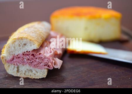 Traditional mortadella sandwich in a rustic setting, selective focus Stock Photo