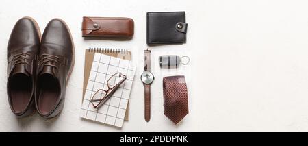 Set of stylish male accessories with notebooks on light background with space for text Stock Photo