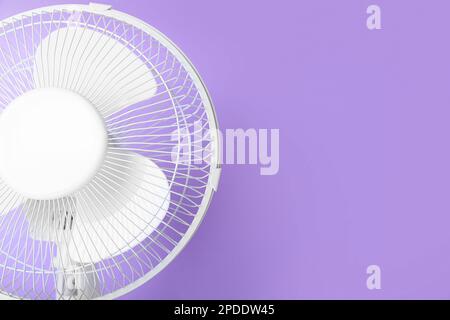 Electric fan on lilac background Stock Photo